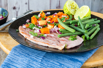 Pan fried gammon with papaya salsa and green beans