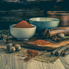 TEX MEX RED CHILLI POWDER on wooden table background. Herbs, spices and dried food baking...