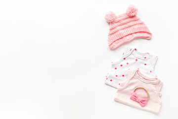 Flat lay of pink baby clothing and accessories. Kids bodysuit and shoes flat lay