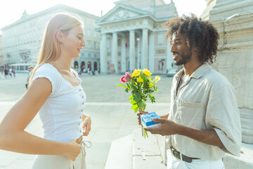 A man is about to propose to his future wife with flowers and a ring