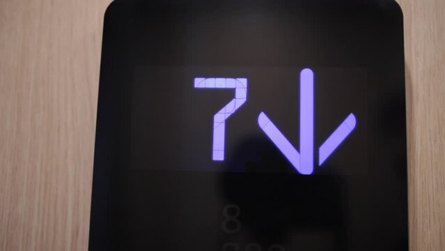In elevator of modern business center on electronic LCD display. View of the panel with the number. The monitor counting numbers from seventh to zero floor.
