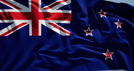 Close-up of the national flag of New Zealand flutters in the wind on a sunny day - 775110287