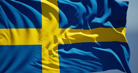 Close-up of the national flag of kingdom Sweden flutters in the wind on a sunny day