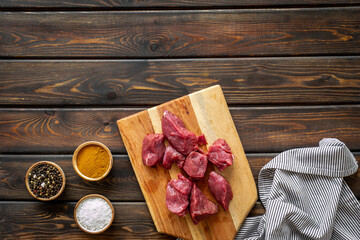 Beef meat on wooden board ready for cooking. Food background