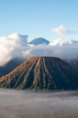 Mount Bromo with smoke, Mount Batok at front, and Mt Gunung Semeru at back, volcano, eruption,...