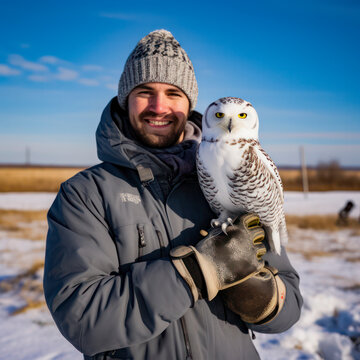 lifestyle photo man holds snowy owl on his arm a533-013099837c42.
