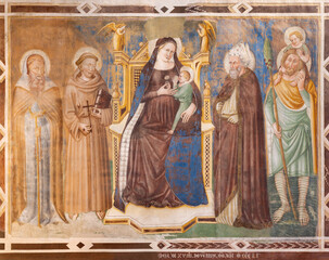 TREVISO, ITALY - NOVEMBER 4, 2023: The fresco of Madonna with saints Anthony abbot, Francis,...