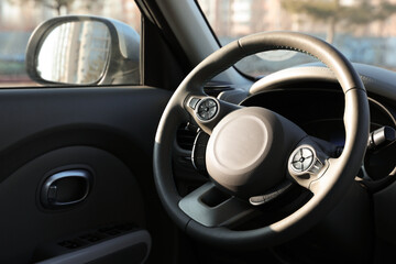 Black steering wheel inside of modern car