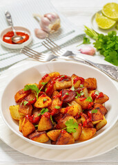 fried spanish potatoes with paprika sauce in bowl