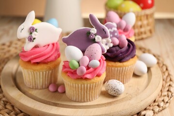 Tasty cupcakes with Easter decor on table