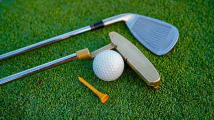  Close up of golf equipment on green grass. - obrazy, fototapety, plakaty