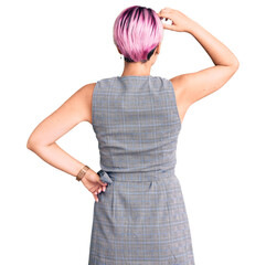 Young beautiful woman with pink hair wearing casual clothes backwards thinking about doubt with hand on head