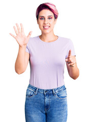 Young beautiful woman with pink hair wearing casual clothes showing and pointing up with fingers number six while smiling confident and happy.