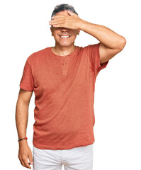 Handsome middle age man wearing casual clothes smiling and laughing with hand on face covering eyes for surprise. blind concept.