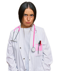 Beautiful hispanic woman wearing doctor uniform and stethoscope skeptic and nervous, frowning upset because of problem. negative person.