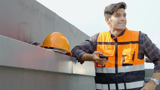 caucasian man, hands and phone in the city for construction planning, communication or social media on site. male contractor or engineer texting on smartphone while resting after working on rooftop 