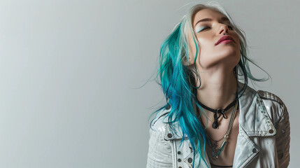 Pretty youthful woman with colorful aqua turquoise hair wearing a white leather jacket.
