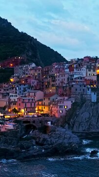 Manarola village popular tourist destination in Cinque Terre National Park a UNESCO World Heritage Site, Liguria, Italy in the evening. Horizontal camera pan