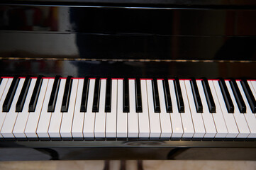 Close up shot of black wooden vintage grand piano keyboard, with black and white keys. Still life....