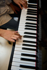 Musician boy playing grand piano during music lesson, performing classical melody, creating and...