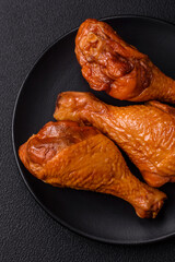 Delicious chicken legs baked on the grill with salt, spices and herbs