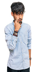 Young hispanic man wearing casual clothes pointing to the eye watching you gesture, suspicious expression