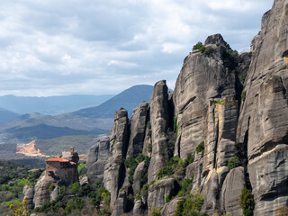 Meteora Monasteries and the surrounding rock formation on a partly cloudy day - obrazy, fototapety, plakaty