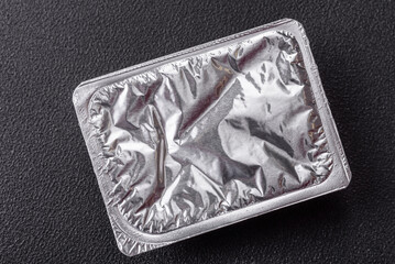 Rectangular plastic box with yogurt or cheese hermetically sealed with a foil lid