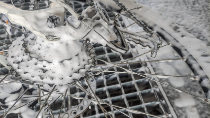The bicycle is washed in a car wash with active foam