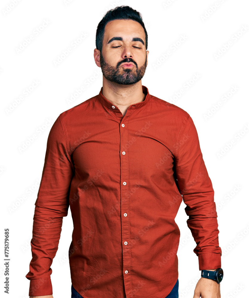 Poster Young hispanic man with beard wearing casual shirt looking at the camera blowing a kiss on air being lovely and sexy. love expression.