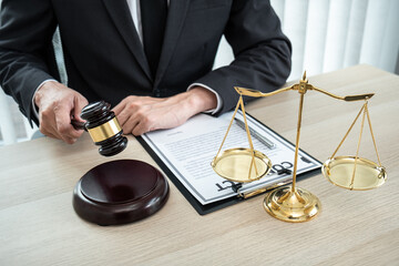 A male lawyer or notary working with contract papers, book and wooden gavel on table in courtroom, Law and Legal services concept - 775180446