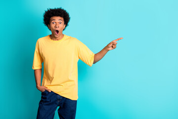 Photo of impressed guy with afro hairdo dressed yellow t-shirt indicating at sale empty space...