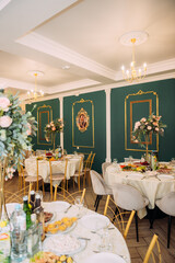 The image shows a dining room table with a chandelier hanging above it and chairs around it 6776.