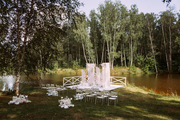 The image shows a wooden structure located in a grassy area near a body of water 6897.