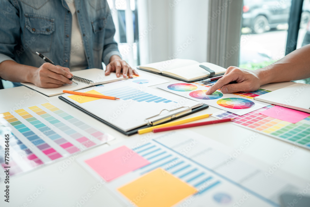 Poster Team of creative graphic designer working on color swatch samples chart for selection coloring in inspiration to create new collection at workplace