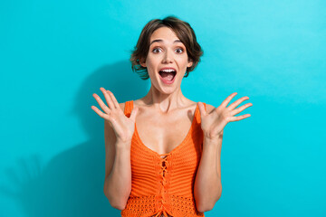 Portrait of crazy eccentric girl with bob hairstyle wear orange knit top raising up palms scream isolated on blue color background - obrazy, fototapety, plakaty