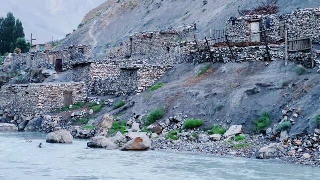 Old villages in Tajikistan. Tajikistan's road along the Zeravshan River near the Pamir highway. Old stone villages in the mountains of the Silk Road. 4К