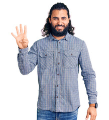 Young arab man wearing casual clothes showing and pointing up with fingers number four while smiling confident and happy.