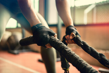 Athlete hands grab rope for body building exercise.