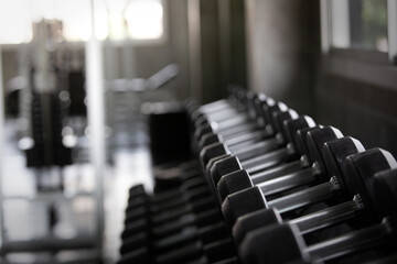 Background view back and white equipment dumbbells on rack in the gym sport center