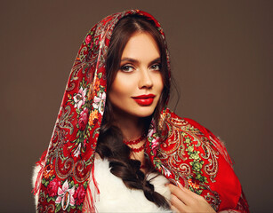 Russian girl Matryoshka style. Fashion woman portrait with traditional red headscarf. Beauty girl...