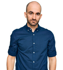 Young hispanic man wearing casual clothes relaxed with serious expression on face. simple and natural looking at the camera.