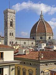 Florence, Italy, Brunelleschi's dome seen from the rooftops of the city, with the light of a sunny...