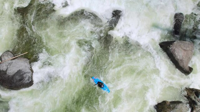 Drone Above Whitewater Kayaker Navigating River Rapids