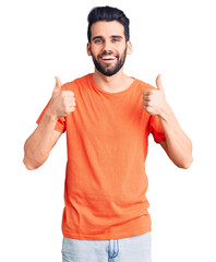 Young handsome man with beard wearing casual t-shirt success sign doing positive gesture with hand, thumbs up smiling and happy. cheerful expression and winner gesture.