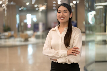 Confident businesswoman smiling in office lobby