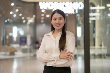 Confident businesswoman smiling in office lobby - 775232099