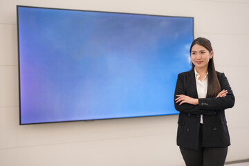 Confident businesswoman presenting with empty display - 775232239