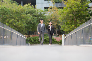 Business professionals walking in modern urban setting - 775232465