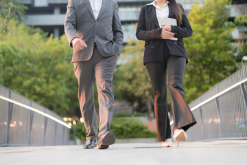 Business professionals walking in modern urban setting - 775232475